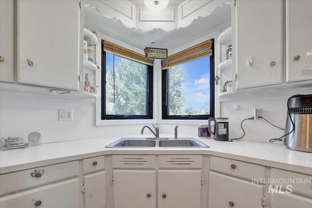 805 Utah, Gooding, ID 83330 - kitchen featuring a sink, white cabinets, light countertops, and healthy amount of natural light