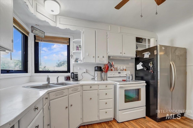 805 Utah, Gooding, ID 83330 - kitchen featuring electric stove, freestanding refrigerator, a sink, and white cabinets