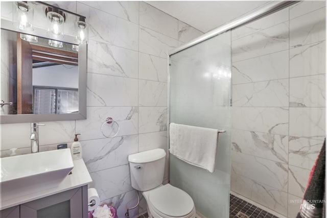 full bathroom featuring toilet, vanity, tile walls, and a shower stall