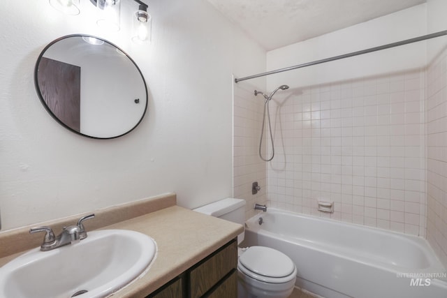 bathroom featuring toilet, vanity, and shower / bathing tub combination