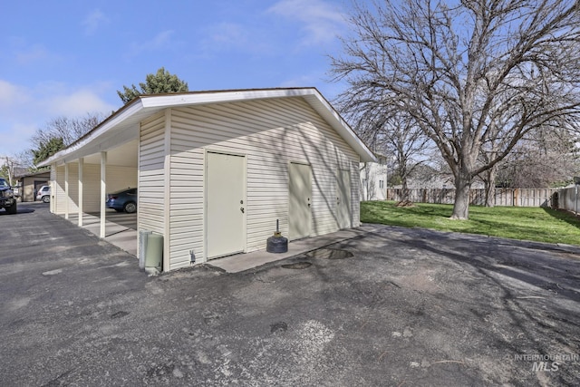view of outbuilding with an outbuilding and fence