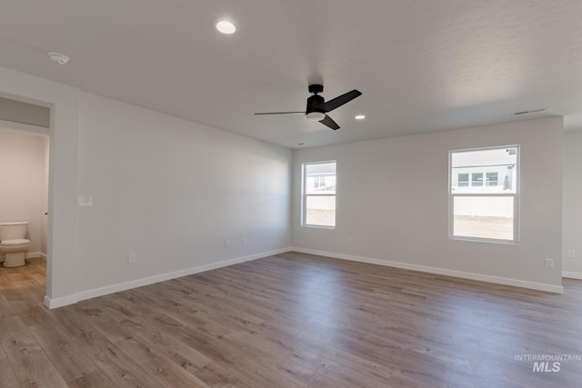 empty room featuring ceiling fan and light hardwood / wood-style flooring