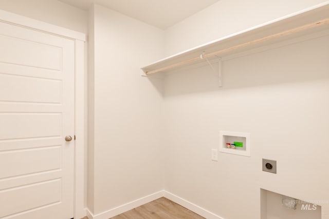 clothes washing area with washer hookup, electric dryer hookup, and wood-type flooring