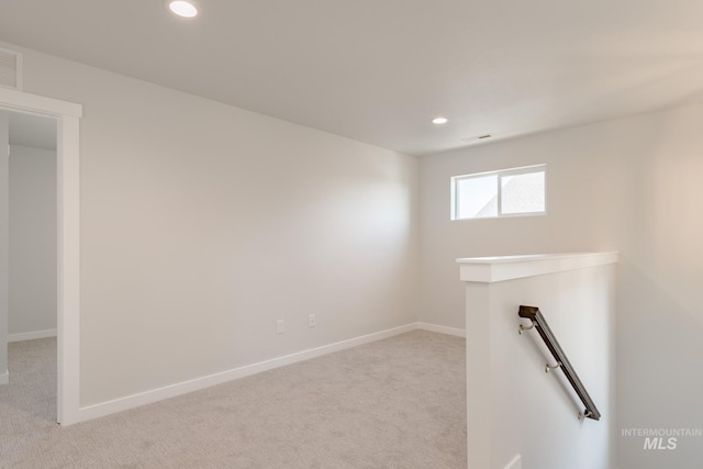 empty room with light colored carpet