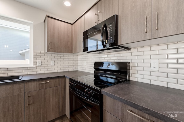 kitchen with black appliances, wood-type flooring, a wealth of natural light, and tasteful backsplash