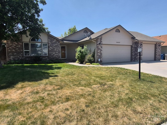 11917 W Stillwater Dr, Boise, ID 83713 - ranch-style house featuring a garage, brick siding, concrete driveway, and a front lawn