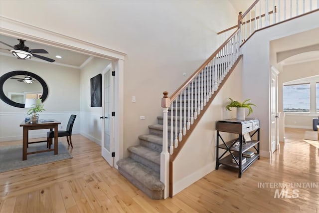 25374 W Deep Canyon Dr, Star, ID 83644 - stairs featuring arched walkways, ceiling fan, wood-type flooring, and baseboards