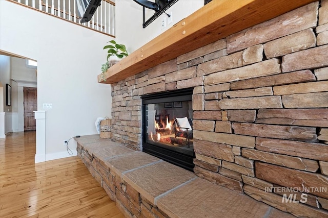25374 W Deep Canyon Dr, Star, ID 83644 - detailed view of wood finished floors, a fireplace, and baseboards