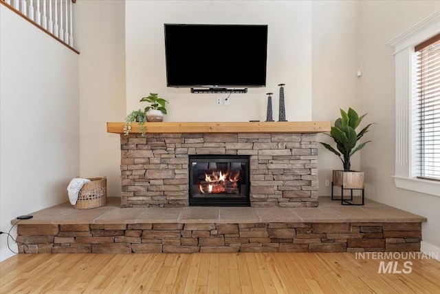 25374 W Deep Canyon Dr, Star, ID 83644 - unfurnished living room with hardwood / wood-style flooring, a fireplace, and plenty of natural light