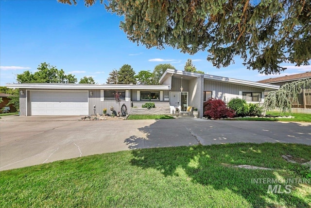 245 Larkspur, Twin Falls, ID 83301 - view of front of house with driveway, a garage, and a front lawn
