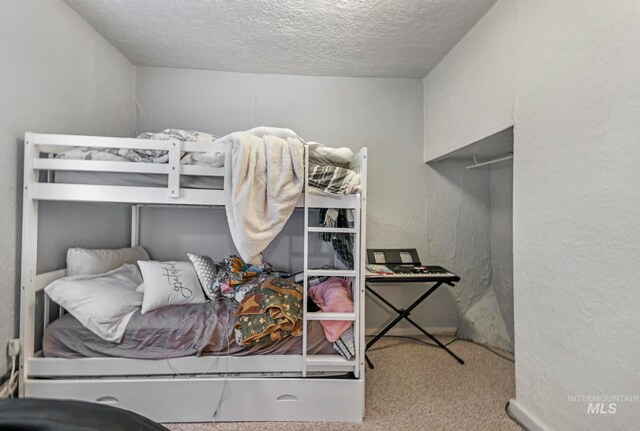 carpeted bedroom with a textured ceiling