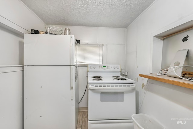 kitchen with white appliances, wood-type flooring, white cabinets, and a textured ceiling