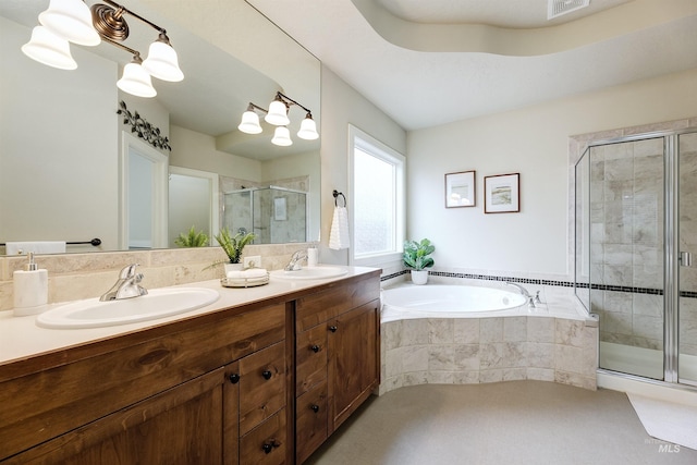 bathroom with a bath, a stall shower, and a sink