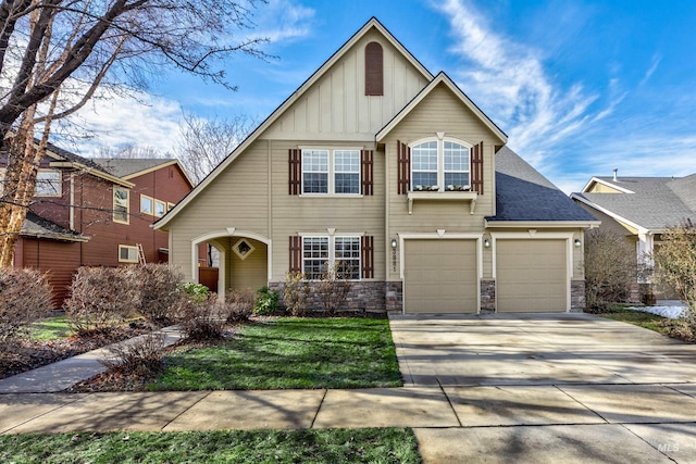 view of front of house featuring an attached garage, driveway, board and batten siding, and stone siding