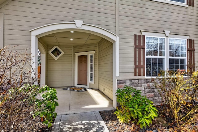 view of exterior entry featuring stone siding