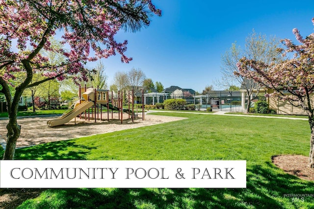 communal playground with a yard and fence