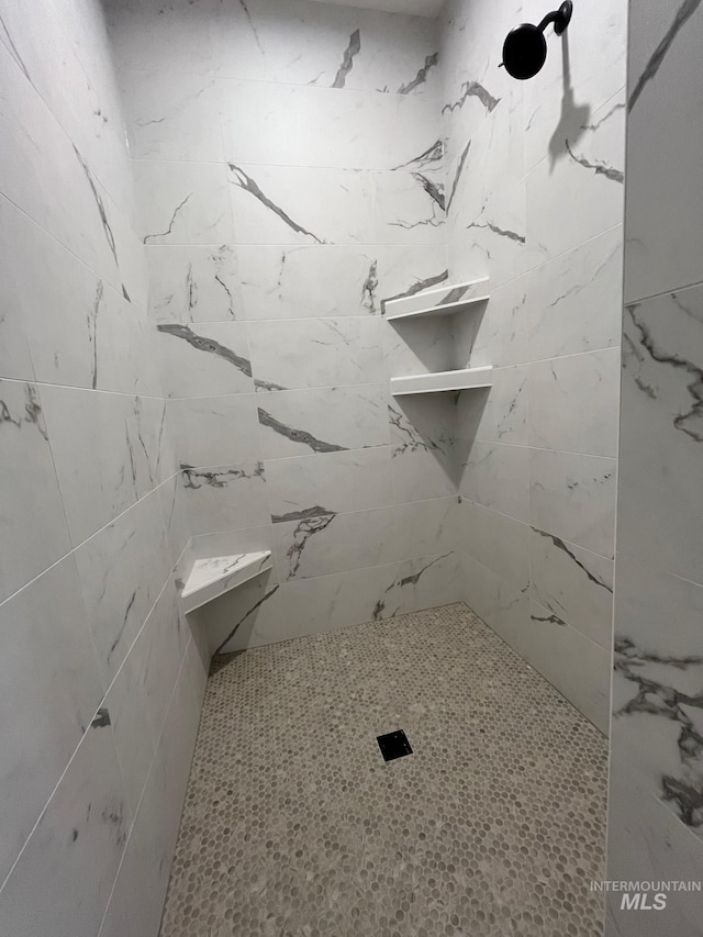 full bath with a tile shower