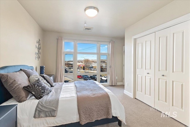 carpeted bedroom featuring a closet