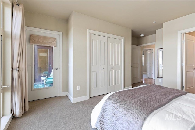 bedroom with light carpet and a closet