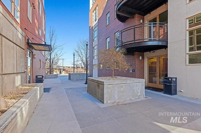 view of patio featuring french doors and a balcony