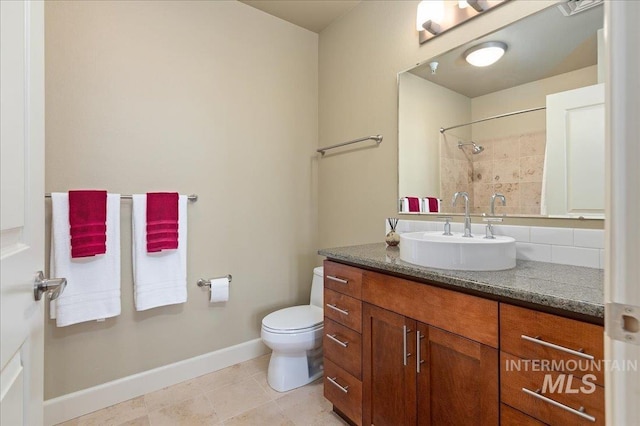 bathroom with decorative backsplash, tile patterned flooring, vanity, and toilet