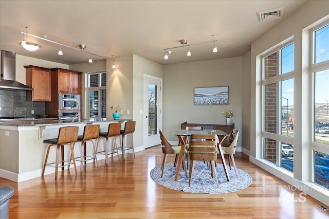 dining space with light hardwood / wood-style flooring