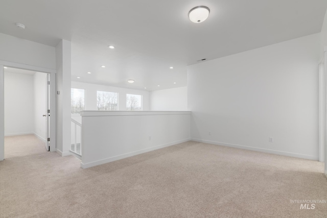 empty room featuring recessed lighting, visible vents, baseboards, and light colored carpet
