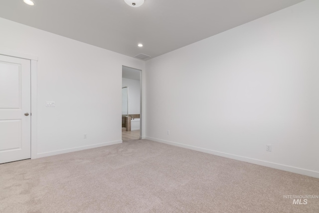 interior space with recessed lighting, light colored carpet, and baseboards