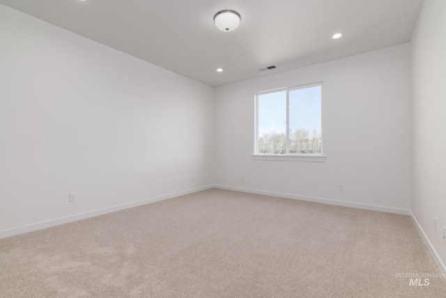 empty room featuring recessed lighting, visible vents, baseboards, and light colored carpet