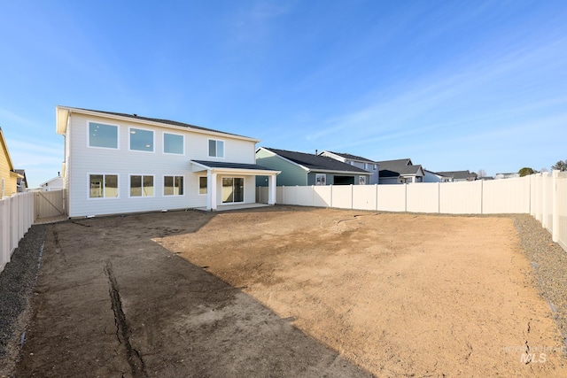 back of property with a patio and a fenced backyard