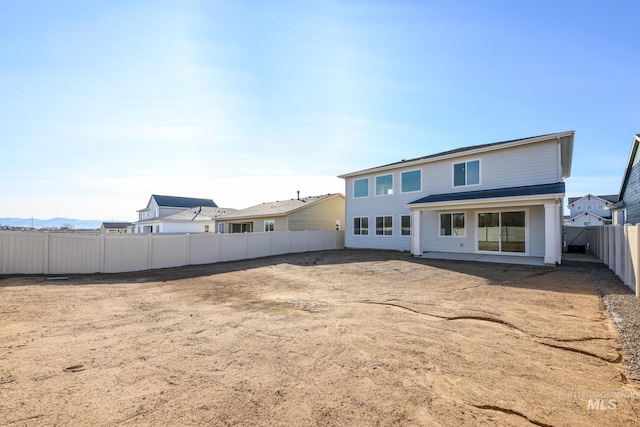 back of property featuring a fenced backyard