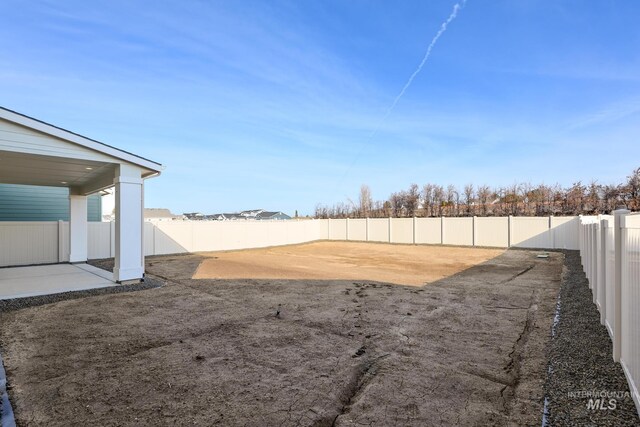 view of yard featuring a patio area and a fenced backyard