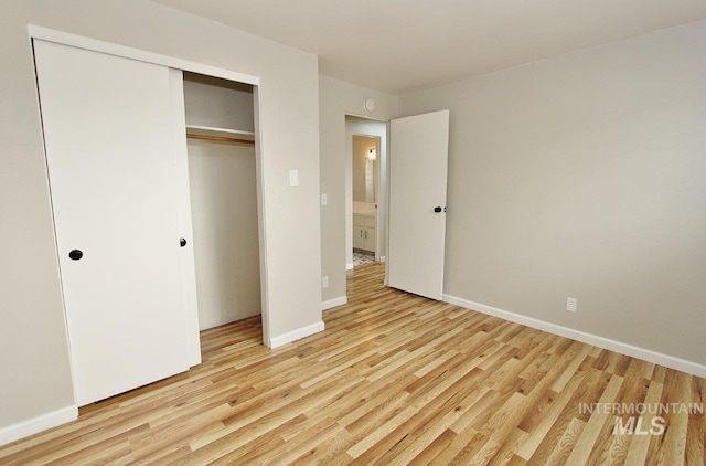 unfurnished bedroom with light hardwood / wood-style floors and a closet