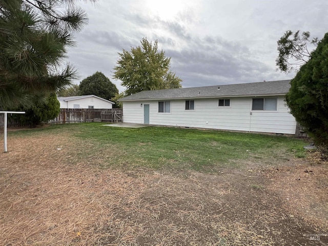 back of house with a yard and a patio area