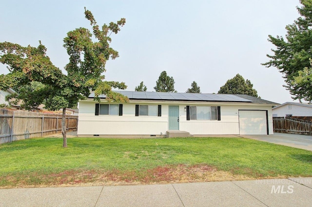 ranch-style house featuring a garage, a front yard, and solar panels