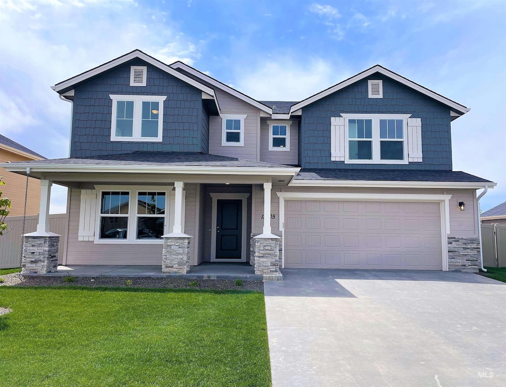 craftsman house featuring a front yard, a porch, and a garage