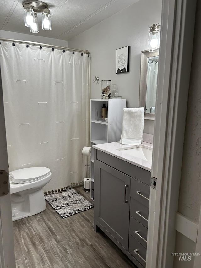 1614 E 1800 S, Gooding, ID 83330 - full bath with toilet, vanity, wood finished floors, and curtained shower