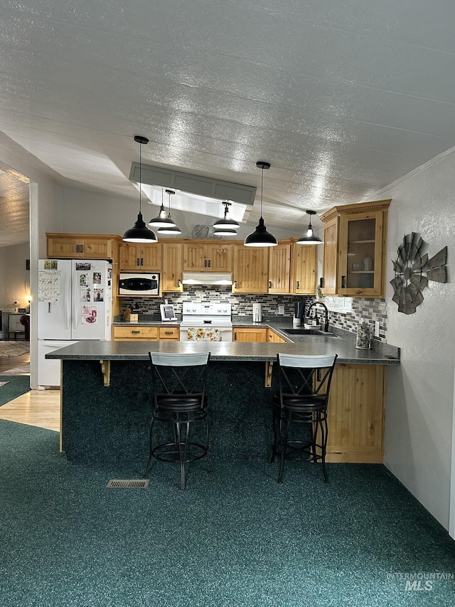 1614 E 1800 S, Gooding, ID 83330 - kitchen with white appliances, under cabinet range hood, a sink, dark countertops, and a textured ceiling