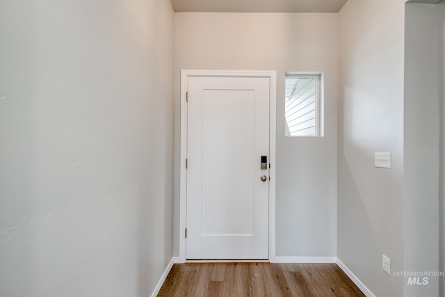 doorway with light wood-type flooring