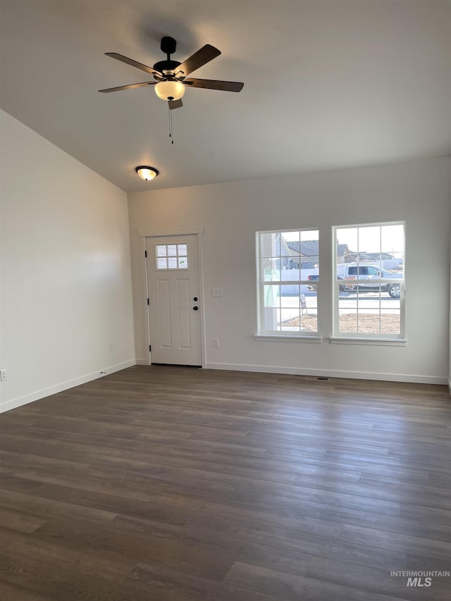 foyer featuring dark wood-style floors, plenty of natural light, and baseboards