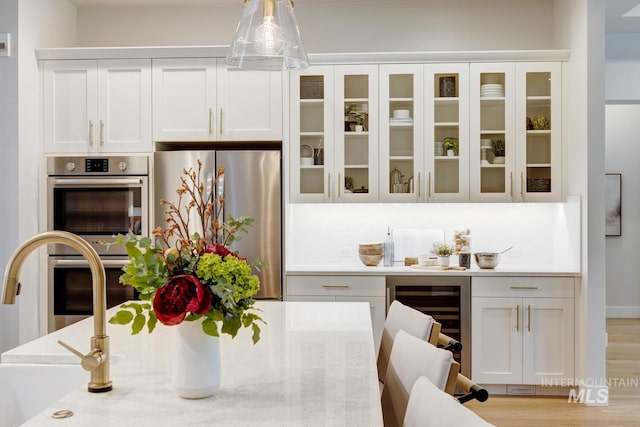 4014 W Farm View Dr, Boise, ID 83714 - kitchen featuring beverage cooler, stainless steel appliances, white cabinets, and glass insert cabinets