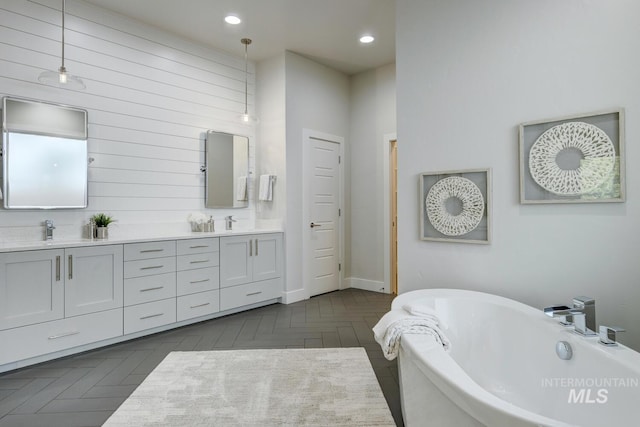 4014 W Farm View Dr, Boise, ID 83714 - full bathroom with double vanity, a soaking tub, baseboards, and recessed lighting
