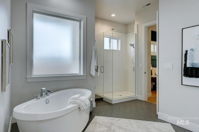 4014 W Farm View Dr, Boise, ID 83714 - ensuite bathroom with a stall shower, a soaking tub, and baseboards