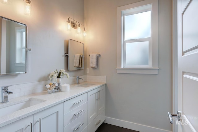 4014 W Farm View Dr, Boise, ID 83714 - full bathroom with double vanity, baseboards, and tasteful backsplash