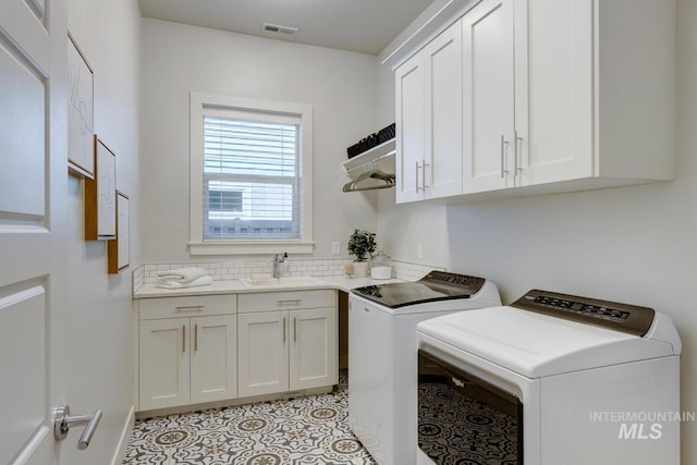 4014 W Farm View Dr, Boise, ID 83714 - laundry room with washer and clothes dryer, cabinet space, and light tile patterned floors