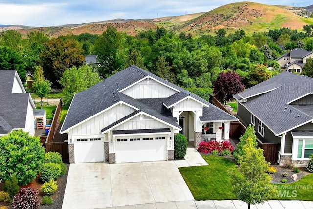 4014 W Farm View Dr, Boise, ID 83714 - view of front of property featuring board and batten siding, roof with shingles, a mountain view, a garage, and driveway