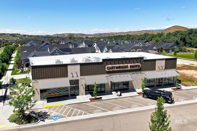 4014 W Farm View Dr, Boise, ID 83714 - view of building exterior with uncovered parking, a mountain view, and a residential view