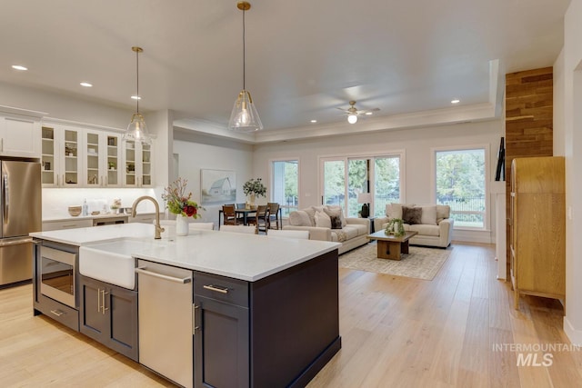 4014 W Farm View Dr, Boise, ID 83714 - kitchen featuring appliances with stainless steel finishes, a sink, white cabinetry, ceiling fan, and light countertops