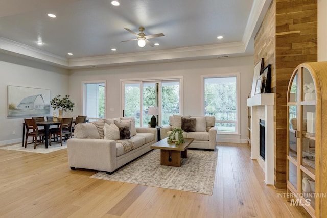 4014 W Farm View Dr, Boise, ID 83714 - living room with a raised ceiling, crown molding, light wood finished floors, a fireplace, and a ceiling fan
