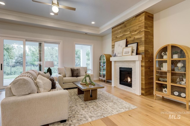 4014 W Farm View Dr, Boise, ID 83714 - living area featuring crown molding, wood finished floors, a ceiling fan, a brick fireplace, and recessed lighting